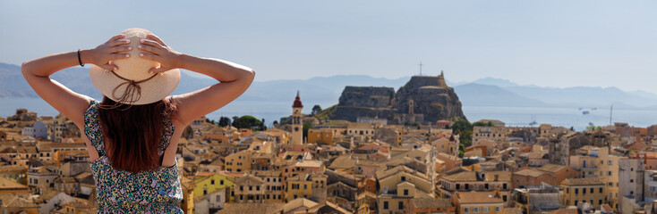 City Break - tourism in Corfu, Greece. Back view of traveler girl enjoying view of Corfu.