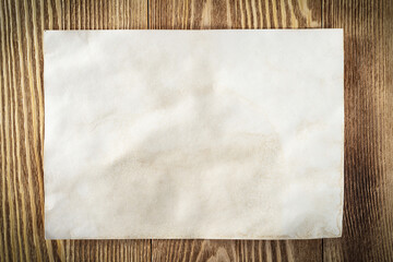 Sheet of paper lying on wooden table