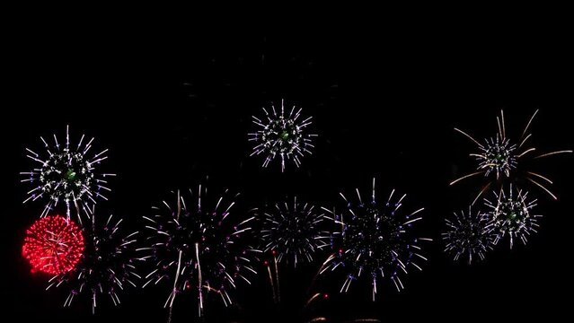 Gleams of colourful fireworks are bursting 4K. loop real fireworks background. Festival Show, Wedding, Confetti, Happy Birthday, Christmas, Diwali, Celebration. New year's eve fireworks celebration