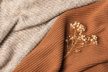 Texture of knitted woolen sweater in warm colors. Warm cozy autumn background.