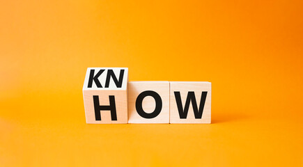 Know how symbol. Turned wooden cubes with words How and Know. Beautiful orange background. Business...