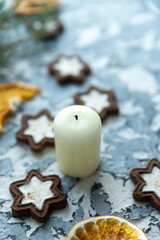 Fototapeta na wymiar Christmas still life candles gray background and gingerbread