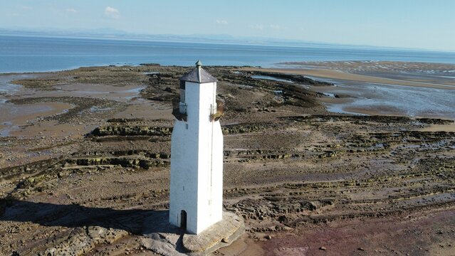 Aerial shot of the lighthouse at Southerness Village in Scotland overlooking the horizon