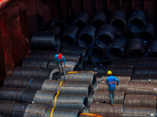 Top view of wire rods in coils stowage into cargo hold of the vessel, Stevedore to prepare for...