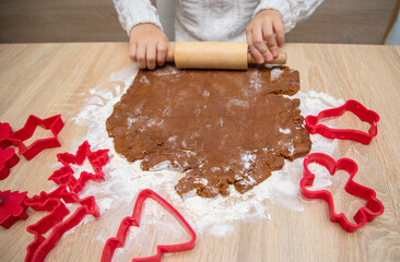 Gingerbread dough for Christmas cookies and cookie cutters.