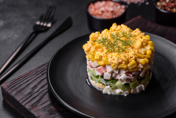 Fresh vegetable salad with corn, pepper, crab, cucumber, eggs and mayonnaise