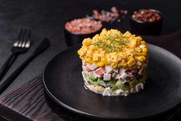 Fresh vegetable salad with corn, pepper, crab, cucumber, eggs and mayonnaise