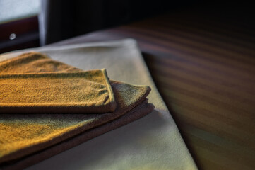 Folded towels. Put it on the bed.