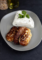 Homemade halloumi from goat milk with the addition of mesophilic sourdough. White Cheese for grilling. An organic dairy product from a local farm.