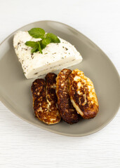 Homemade halloumi from goat milk with the addition of mesophilic sourdough. White Cheese for grilling. An organic dairy product from a local farm.