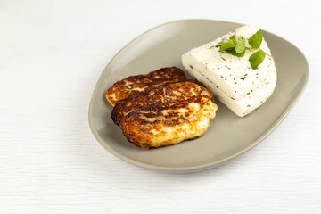Homemade halloumi from goat milk with the addition of mesophilic sourdough. White Cheese for grilling. An organic dairy product from a local farm.