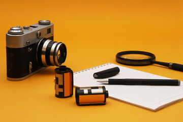 A film camera on a photojournalist's desk. Shallow depth of field