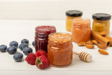 Jar of honey. Fruit honey with raspberries and blueberries.Useful fortified beekeeping product for health and beauty.Cream honey.Vegetarian diet organic product.Copy space. place for text