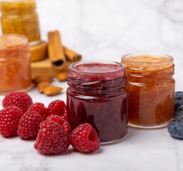 Jar of honey. Fruit honey with raspberries and blueberries.Useful fortified beekeeping product for health and beauty.Cream honey.Vegetarian diet organic product.Copy space. place for text