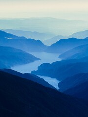 Vertical blue landscape of hills © Florin Popescu/Wirestock Creators