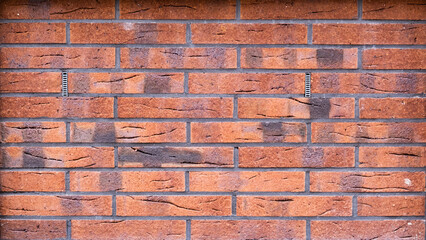 Texture of red-brown brick wall. Background from bricks of bright color. Solid brick texture. Beautiful and bright camp
