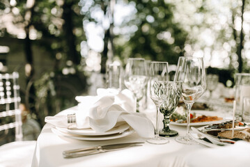 Beautiful wine glasses on a set table outdoors