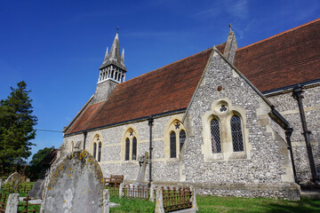 Fototapeta premium rural church in English countryside. Traditional stone church viewed from graveyard. 