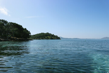 Beautiful turquoise mediterranean waters with mountains around in spanish island 