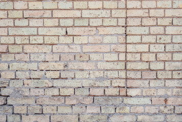 Texture of a beige light brick wall. Background from bricks of bright color. Solid brick texture. Beautiful and bright camp