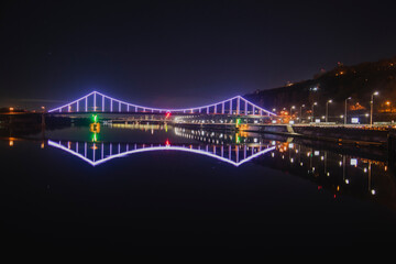 Fototapeta na wymiar KIEV, UKRAINE - JANUARY 6, 2020: PARK BRIDGE (pedestrian bridge) ILLUMINATED BY NIGHT
