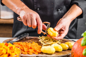 mid section of chef preparing fresh organic ingredients for pumpkin soup