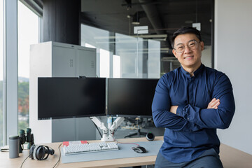 Portrait of successful programmer in modern office of development company, asian man with crossed...