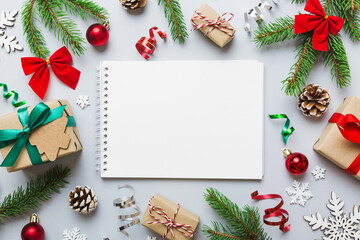 Christmas blank greeting card mock-up scene. Creative layout made of Christmas tree branches and paper card note. Flat lay. Nature New Year concept