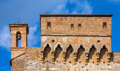 A very small bell tower attached to a medieval building