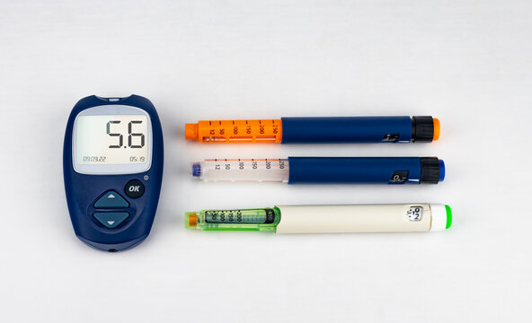 Blood Glucose Meter And Syringe Pens On A White Background