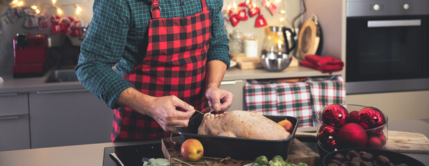 Man preparing delicious and healthy Christmas duck in home kitchen.