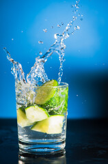 Green healthy cucumber water splashing freshness on blue background