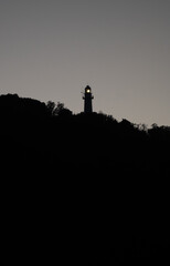 lighthouse on the mountain in silhouette