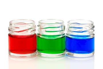 Small glass jars filled with colored water