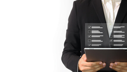 Businessman in black suit hold tablet checking on checklist, clipboard task management . Business...