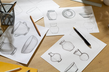 The designer draws sketches of dishes on paper. The artist creates kitchen utensils for production.