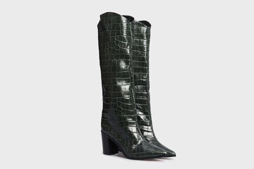 Emerald Green women's knee high boots in crocodile skin leather. isolated on white background. Female classic glossy fashion shoes with Pointy Toe, high heel. Spring autumn season. Template, mock up