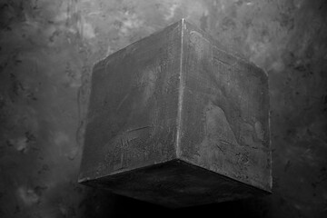 Concrete cube shape on floor background texture. Cement block as abstract concept