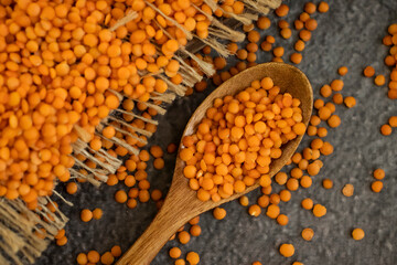 Dry lentils spoon on wooden background