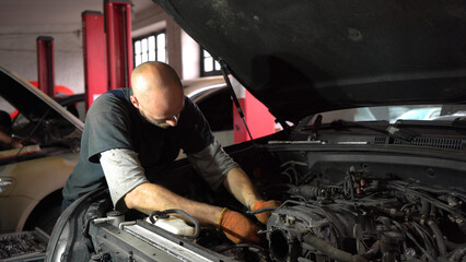 Fototapeta na wymiar Auto mechanic repairs car engine. car service. close-up.