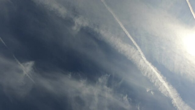 Contrails left from transatlantic aircraft with passing planes racing across the sky like shooting stars.
