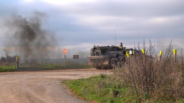 British Army Challenger 2 ii Tank Armored Repair and Recovery Vehicle (CRARRV) crossing a road junction in action on a military exercise