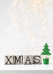 Vintage word "Xmas". New year decorations in rustic style. Letter on pastel background.
