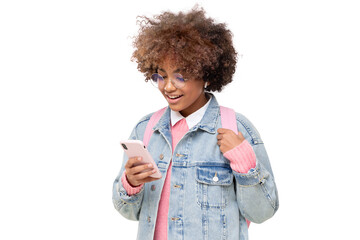 African school girl with afro hairstyle and backpack holding smartphone with one hand, chatting with friend, using social media app, isolated
