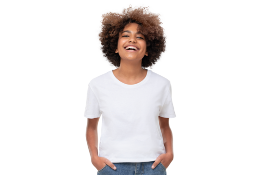 Front view of laughing african teen girl standing with hands in pockets, wearing white tshirt with copy space