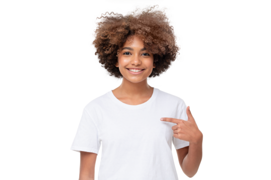 African student girl pointing with index finger at blank white t-shirt with empty space for your advertising text or image, standing isolated