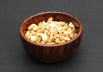 Indian snack food salted peanuts in a wooden bowl 