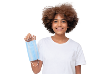 Smiling african school girl holding face mask after the end of pandemic. Coronavirus defeated, people are getting back to normal life