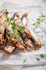 Salty smoked sprats marinated with spices and salt.