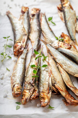 Salty smoked sprats with herbs and salt.